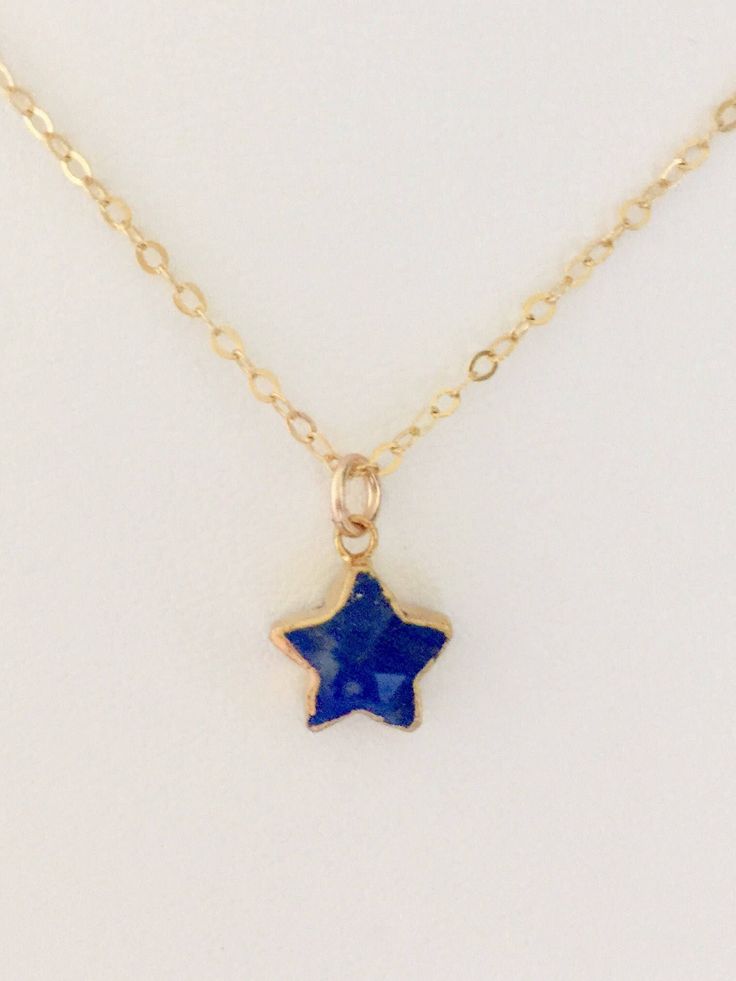 "Adorable rich blue petite lapis lazuli star pendant on delicate gold fill chain. Gold electroplated pendant is 11 x 11 x 5 mm. Delicate sparkling 14k gold fill chain closes with spring ring clasp and comes in several lengths. Total drop with bail is 5/8\". Darling worn alone or layered with other pieces." Dainty Blue Jewelry With Star Charm, Blue Star Charm Jewelry, Blue Star Charm Necklace As Gift, Blue Star Charm Necklace As A Gift, Blue Necklace With Star Charm As A Gift, Blue Star Charm Necklace For Gift, Blue Star-shaped Birthstone Jewelry, Star-shaped Blue Birthstone Jewelry, Lapis Necklace