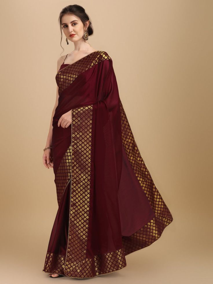 Maroon and gold-toned sareeSolid woven design saree with woven design borderHas patchwork detailThe saree comes with an unstitched blouse pieceThe blouse worn by the model might be for modelling purpose only. Check the image of the blouse piece to understand how the actual blouse piece looks like. Bollywood Style Pre-draped Saree With Border For Eid, Navratri Pre-draped Saree With Border, Diwali Cotton Silk Pre-draped Saree With Border, Diwali Dola Silk Pre-draped Saree With Border, Diwali Pre-draped Saree With Zari Weaving, Gold Art Silk Pre-draped Saree With Border, Bollywood Banarasi Silk Pre-draped Saree With Border, Eid Art Silk Pre-draped Saree With Pallu, Festive Banarasi Silk Pre-draped Saree With Border