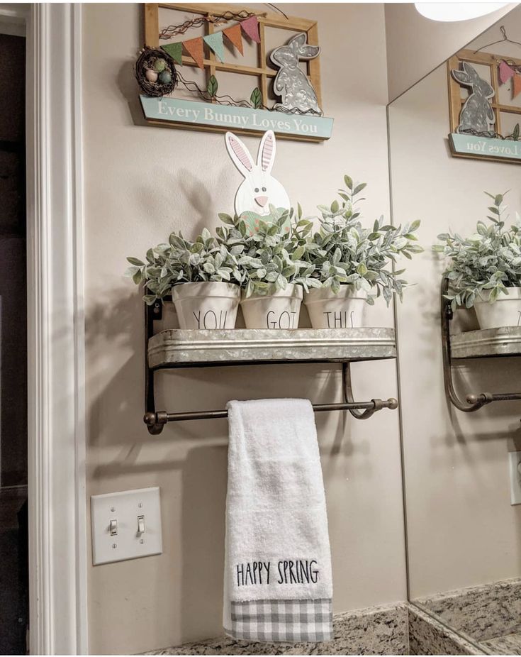 the bathroom is decorated with plants and towels