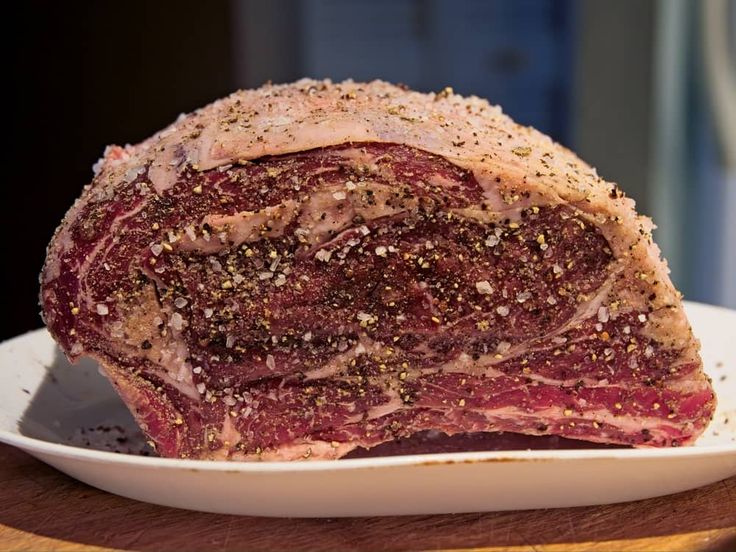 a large piece of meat sitting on top of a white plate