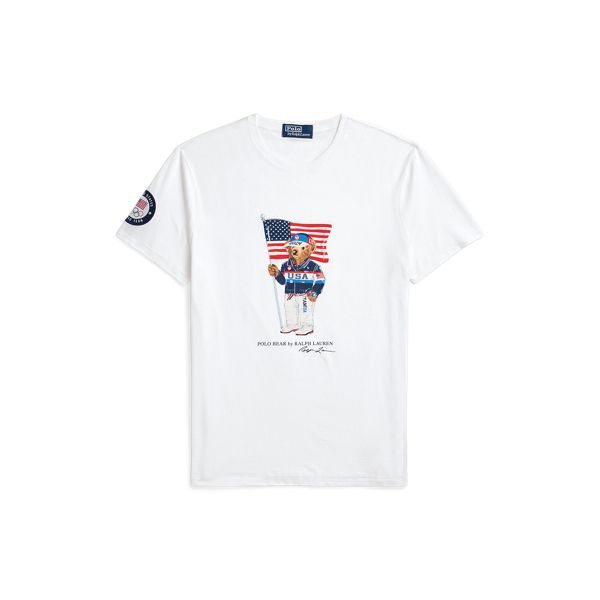 Part of the Polo Ralph Lauren Team USA Collection this Custom Slim Fit T-shirt features our iconic Polo Bear sporting the uniform Ralph Lauren designed for Team USA's flagbearer to wear during the Closing Ceremony of the Olympic and Paralympic Games Paris 2024. Ralph Lauren Sporty Graphic Print T-shirt, Sporty Cotton T-shirt With Flag Print, Sporty Ralph Lauren Cotton T-shirt, Ralph Lauren Crew Neck Tops With Letter Print, Ralph Lauren Sporty T-shirt With Graphic Print, Sporty Ralph Lauren T-shirt With Graphic Print, Sporty Ralph Lauren Tops With Graphic Print, Sporty Ralph Lauren Graphic Print Tops, Sporty Ralph Lauren Top With Graphic Print