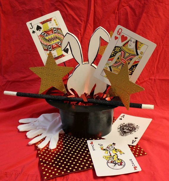 a magician's hat with cards and gloves on it, next to some playing cards