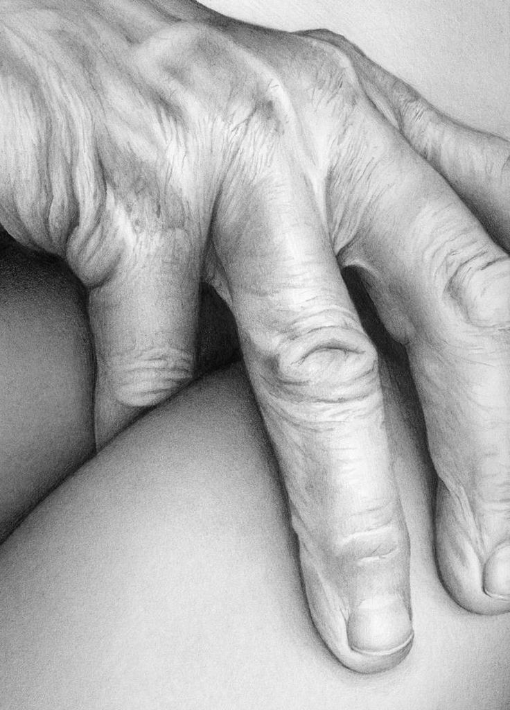 a black and white photo of an older person's hand