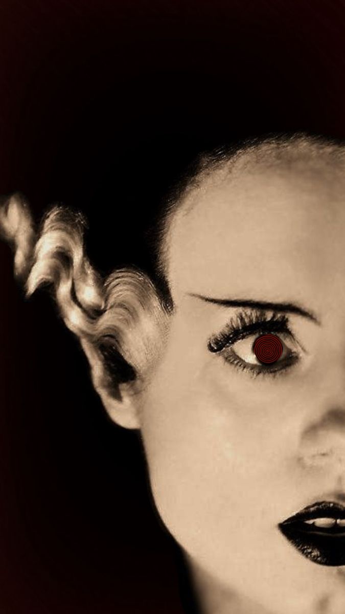 a woman with red eyes and black makeup