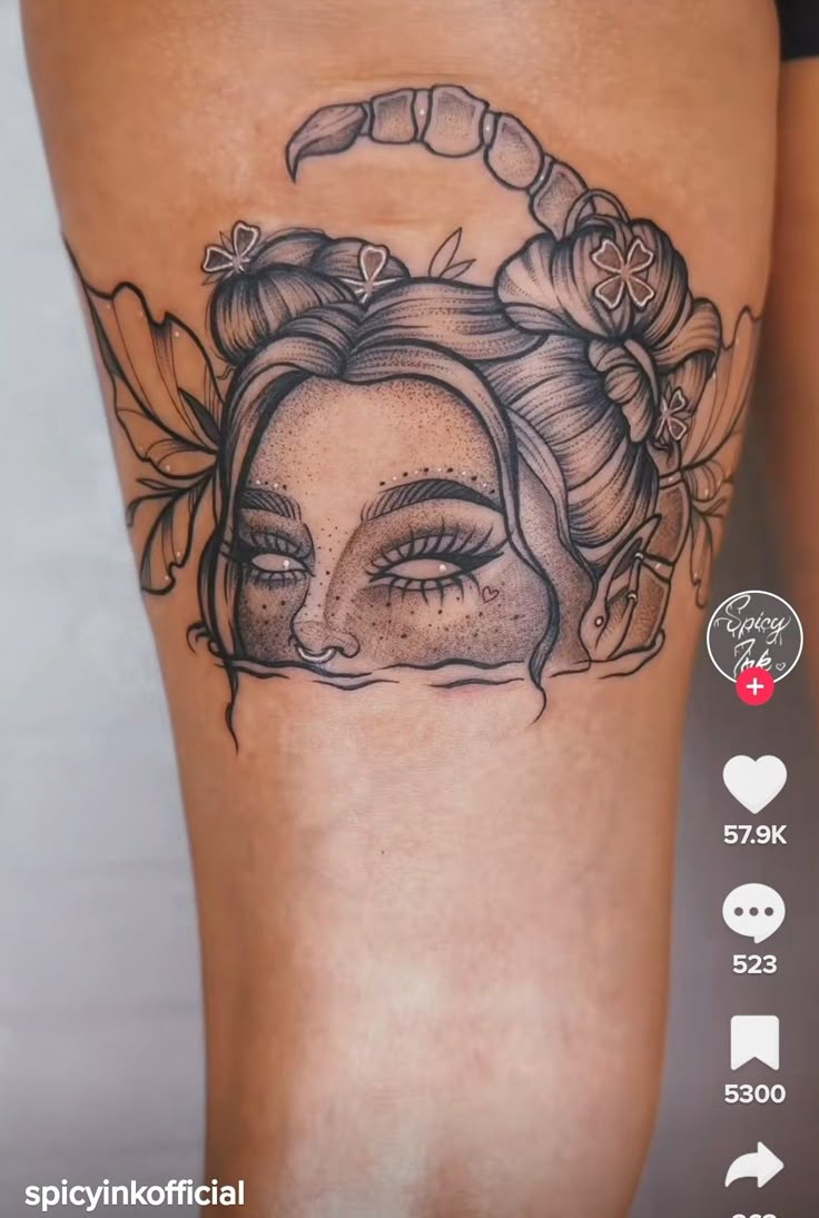 a woman's leg with tattoos on it