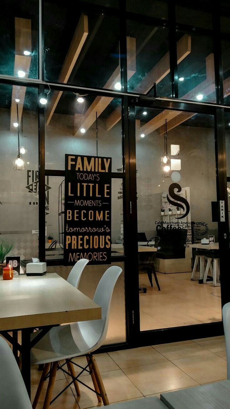 the inside of a restaurant with chairs and tables in front of glass doors that read family little become precious precious precious memories