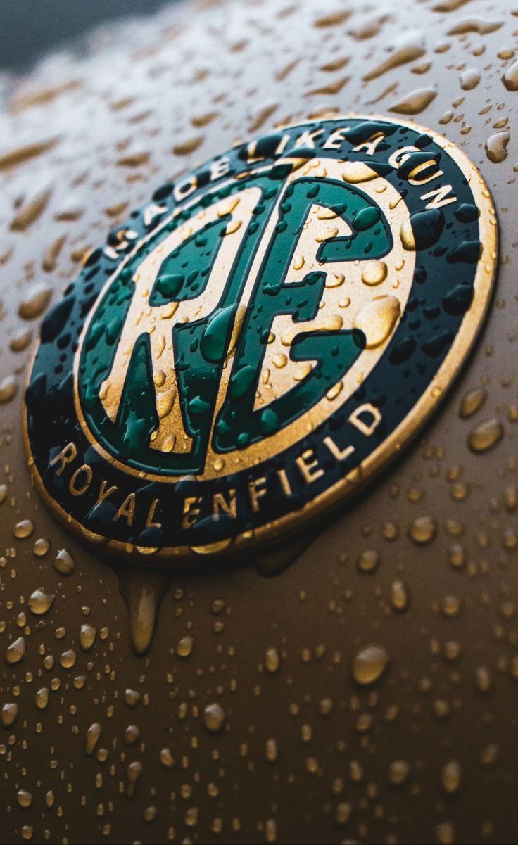 the royal enfield logo is covered in raindrops