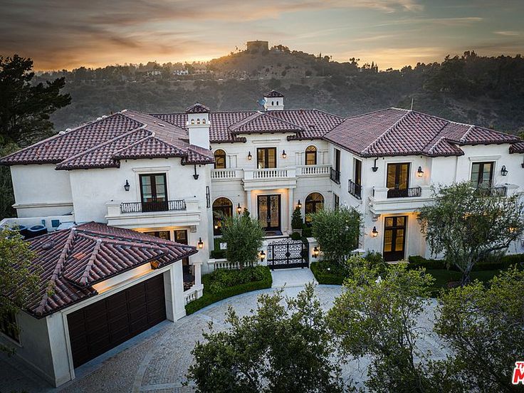 this is an aerial view of a home in the hills at sunset or sunrise time