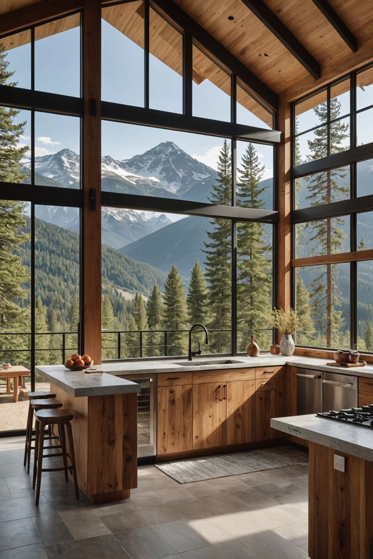 an open kitchen with large windows overlooking the mountains