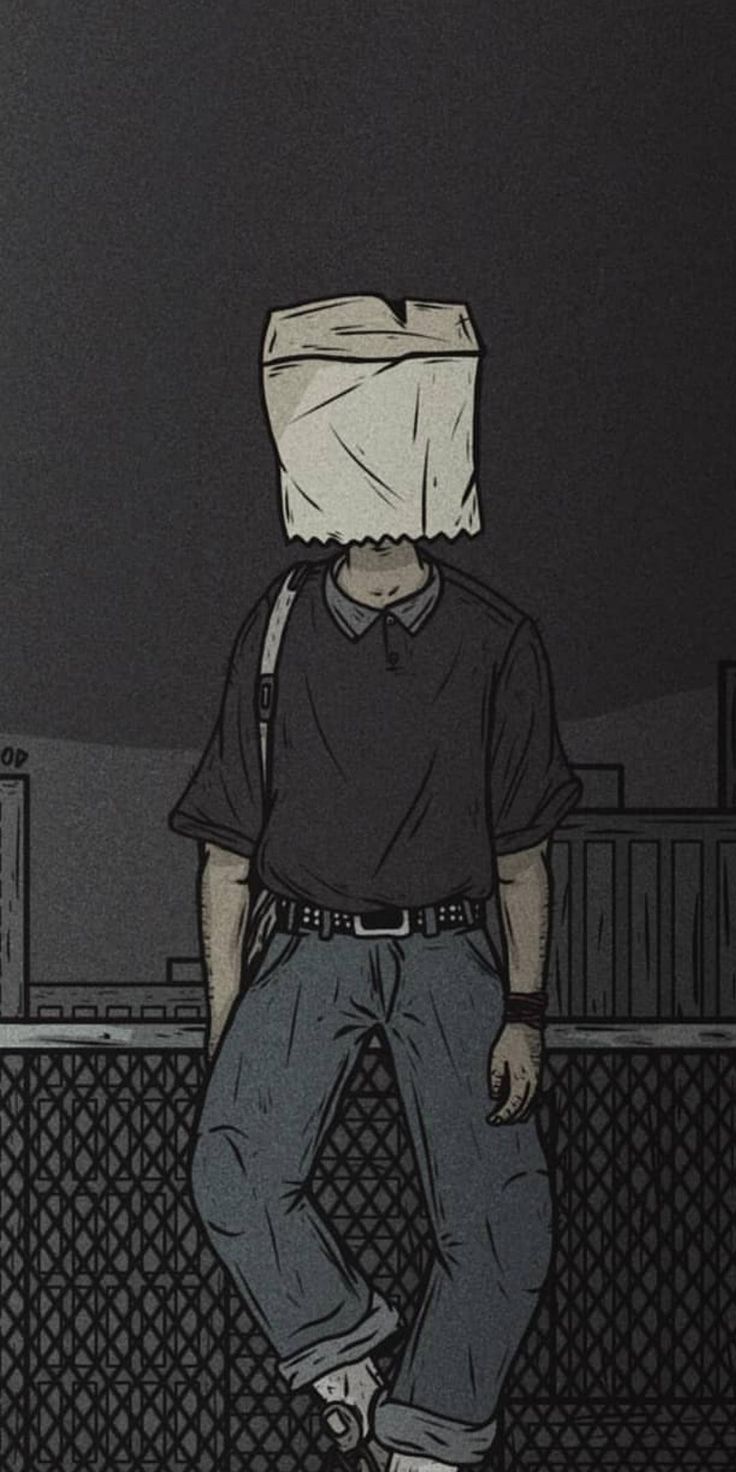 a man with a paper bag on his head standing in front of a fence at night