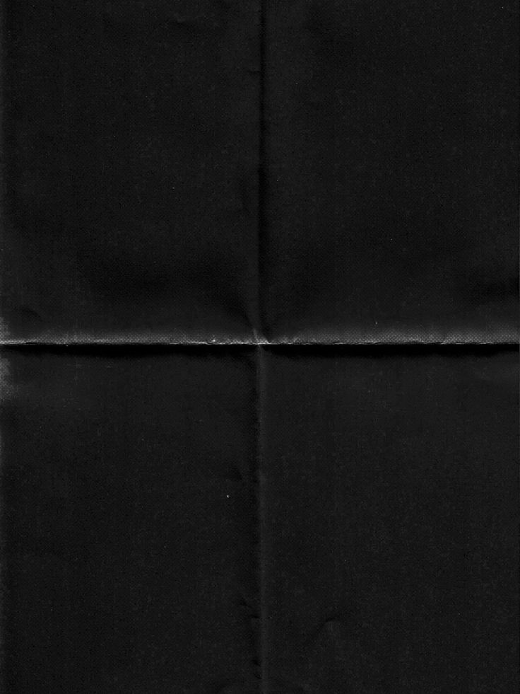 a black piece of paper that has been folded in two rows and is slightly visible