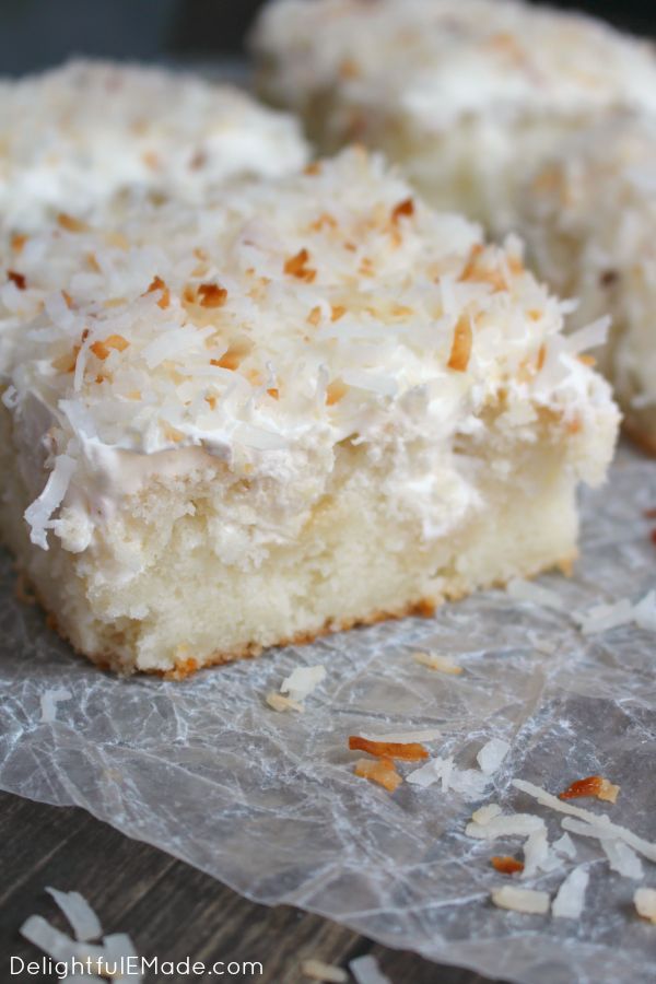 a piece of coconut cake on top of wax paper