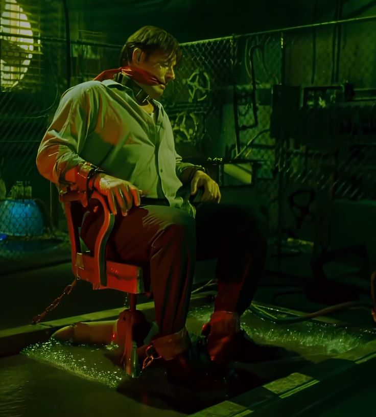 a man sitting on top of a red chair