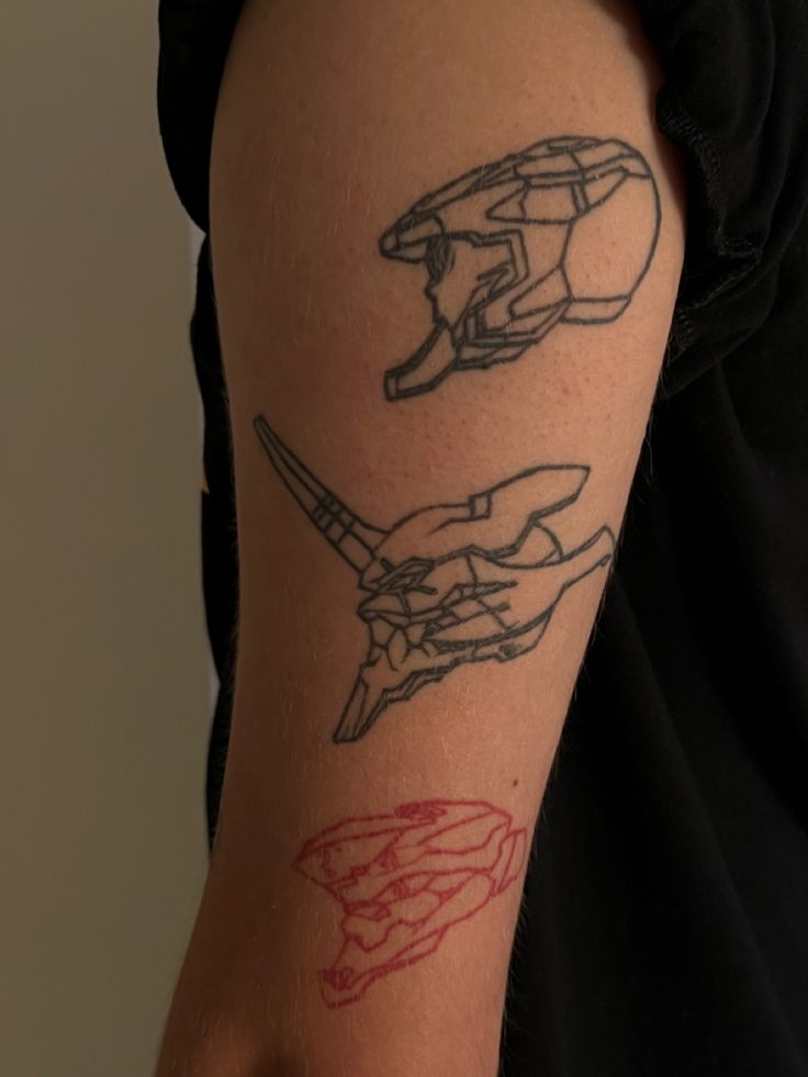 a person with a tattoo on their arm that has two hands holding scissors in it