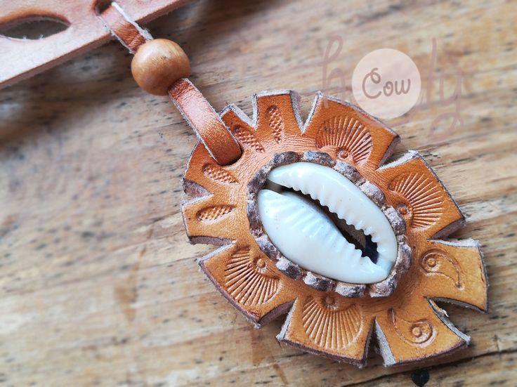 This beautiful handmade leather necklace is made from the finest quality brown leather. It has beautiful sea shell incorporated into it's design. It is adjustable at the back so it fits all sizes. The product is new and can be shipped immediately. Handmade Brown Cowrie Shell Jewelry, Bohemian Brown Cowrie Shell Jewelry, Handmade Brown Shell Necklace, Handmade Brown Shell-shaped Necklace, Handmade Brown Shell Necklace For Gift, Unique Handmade Brown Shell Necklace, Bohemian Brown Shell-shaped Jewelry, Handmade Brown Shell Necklace For Beach, Handmade Adjustable Brown Shell Necklace