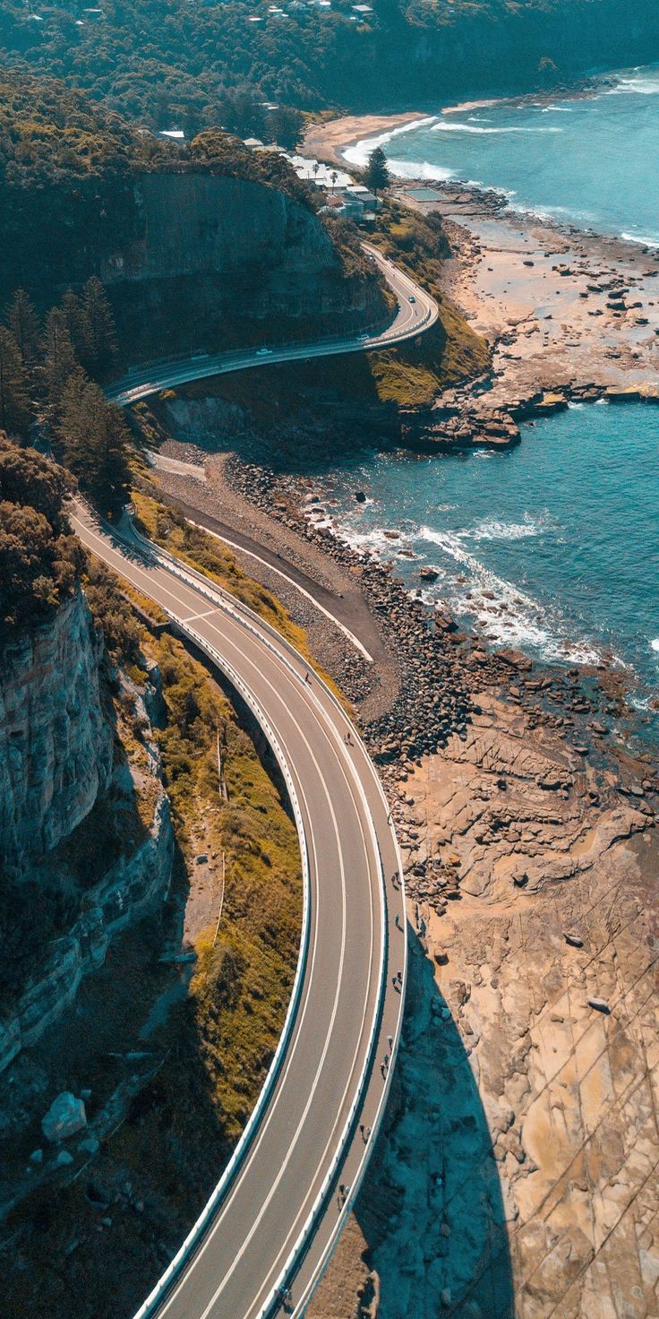 an aerial view of a highway near the ocean