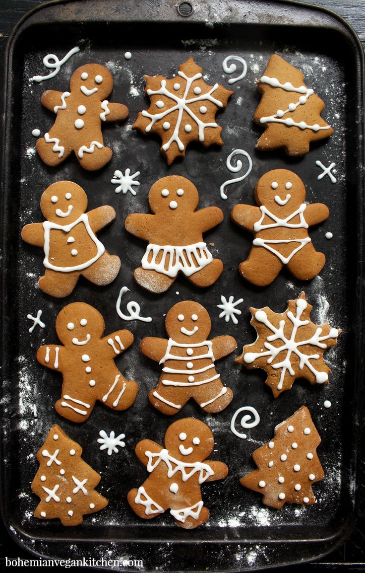 gingerbread cookies decorated with icing on a baking sheet