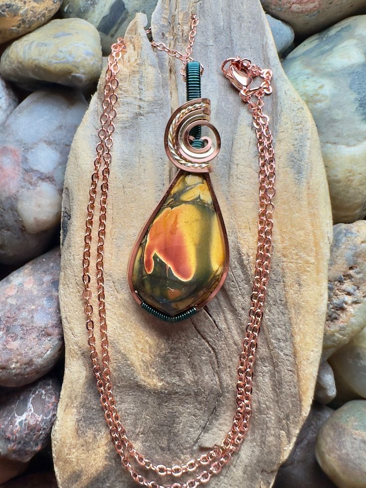 Cherry Creek jasper with copper, gold, and teal wire wrap Comes with 18" sterling silver plated chain shown in photos.  Pendant measures  1-7/8" x  11/16" Unique Multicolor Copper Necklace, Multicolor Copper Necklace, Turquoise Necklace With Copper Wire, Hand Wrapped Copper Gold Necklace, Hand Wrapped Gold Copper Necklace, Wire Wrapped Turquoise Pendant Necklace, Wire Wrapped Copper Wire Teardrop Pendant Necklace, Unique Wire Wrapped Turquoise Pendant Necklace, Unique Wire-wrapped Turquoise Pendant Necklace