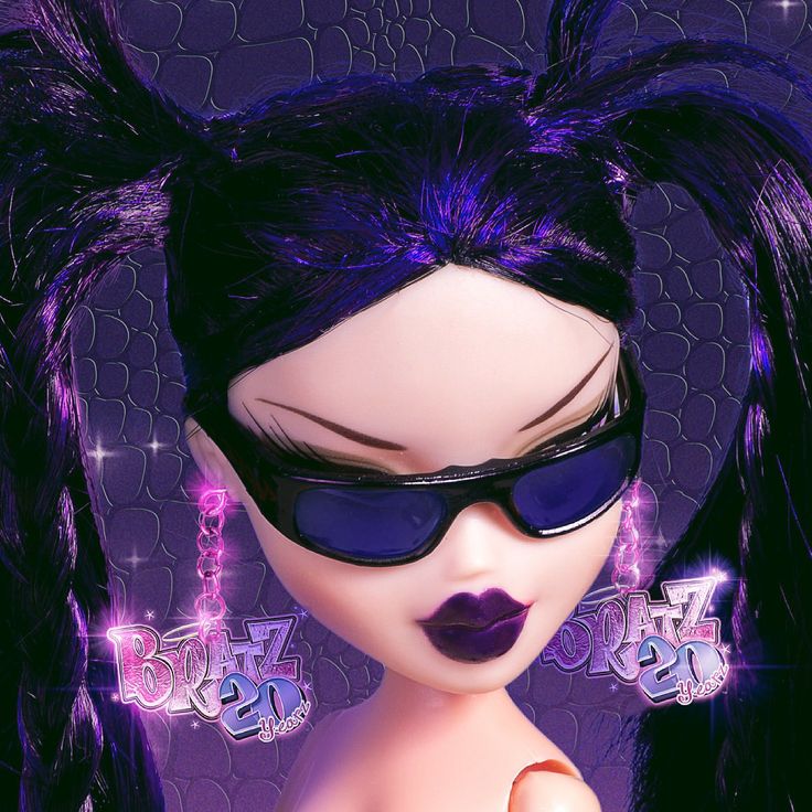 a close up of a doll with purple hair and sunglasses on it's face