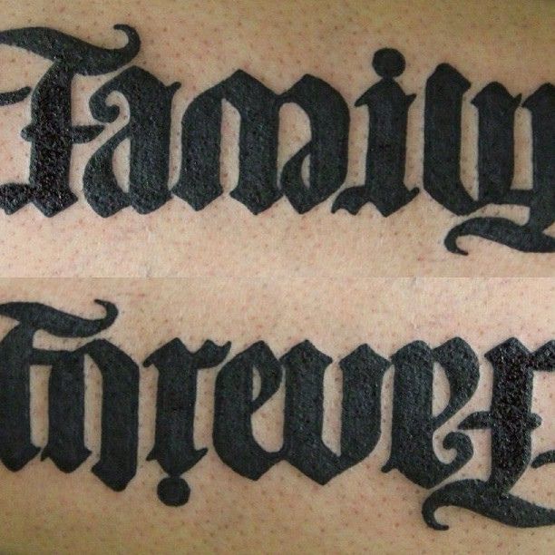 the words family forever are written in cursive black ink on a man's arm