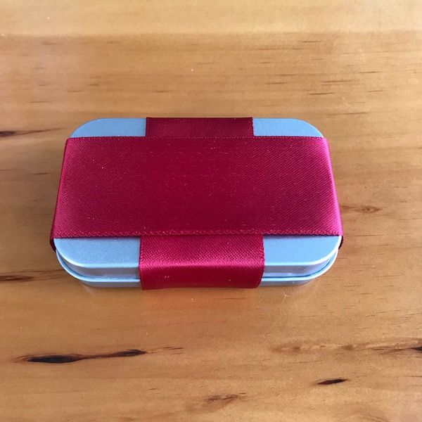 a red and blue box sitting on top of a wooden table