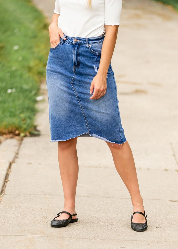 The Tiana Distressed Denim Midi Skirt is a modest and cute denim midi skirt! Designed with backed distressing at the front and back pockets, an uneven raw hem, 5 pockets for holding all the things, and a classic button zipper closure. Style: distressed, denim, midi length Color: Denim Quality control is of the utmost importance to us. Our sizing is always approximate and can also depend heavily on your own body shape. Just like no two people are the same, the same goes for skirts, dresses + tops Spring Denim Skirt In Dark Wash With Unfinished Hem, Medium Wash Denim Skirt With Unfinished Hem, Spring Dark Wash Denim Skirt With Unfinished Hem, Knee-length Medium Wash Bottoms With Frayed Hem, Cutoff Denim Skirt With Frayed Hem, Knee-length Denim Skirt With Frayed Hem, Knee-length Denim Blue Skirt With Frayed Hem, Mid-rise Medium Wash Denim Skirt With Frayed Hem, Dark Wash Knee-length Bottoms With Frayed Hem