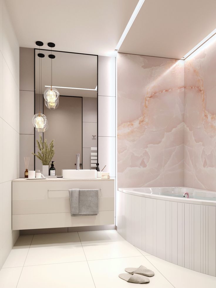 a bathroom with marble walls and flooring next to a large bathtub in front of a mirror