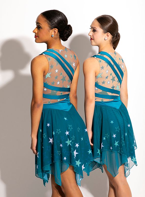 two women in blue dresses standing next to each other with their backs turned towards the camera