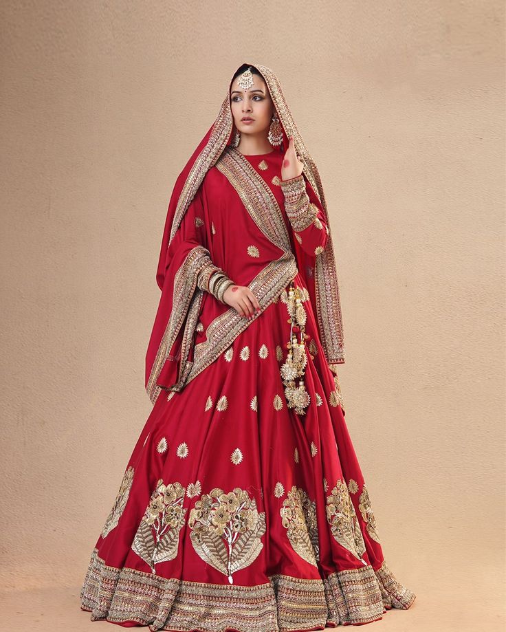 Embrace timeless elegance with our designer Champa Gotapatti Buta Lehenga, a masterpiece of artistry and craftsmanship. Golden gota patti and kasab dori intricately blend with a heavy zardozi border, adorning this stunning bridal Sindoori Red lehenga. Paired with a full embroidered blouse featuring exquisite gota patti butas, this ensemble exudes grace and sophistication. Completing the look is a red Chanderi silk dupatta, adorned with delicate Gota Patti and zardozi borders, as well as... Gotapatti Bridal Lehenga, Gotapatti Lehenga, Lehenga Red Bridal, Zardozi Border, Red Bridal Lehenga, Bridal Lehenga Online, Lehenga Bridal, Lehenga Red, Maroon Wedding