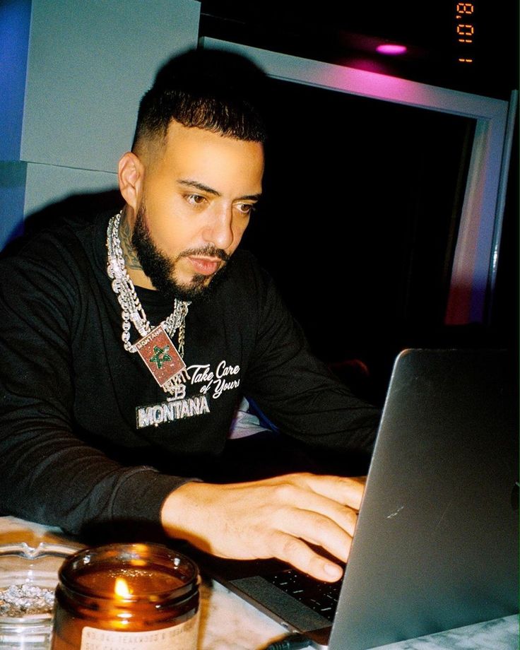 a man sitting in front of a laptop computer