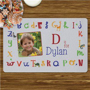 a mouse pad with a child's photo and alphabets on the front side