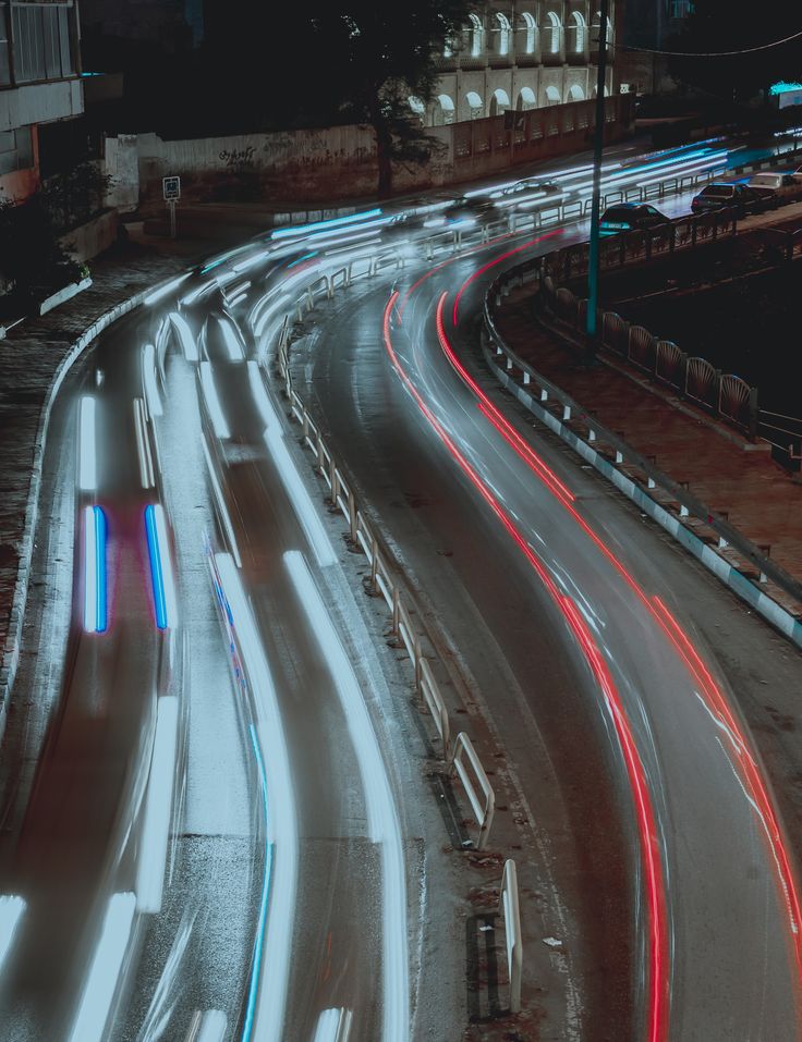 the city street is busy with traffic at night