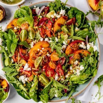 a salad with tomatoes, lettuce and feta cheese