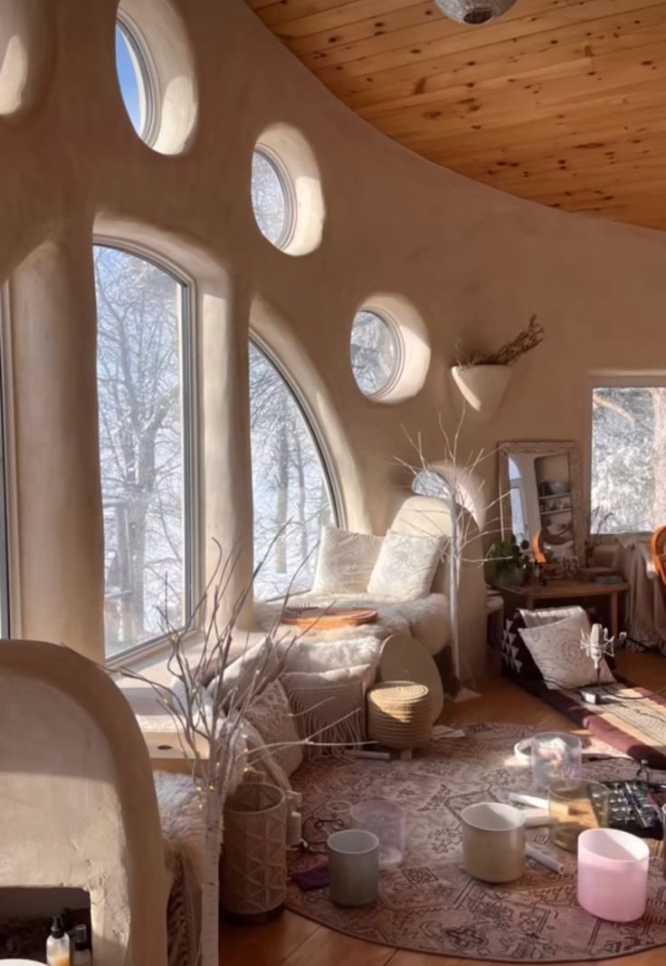 a living room filled with furniture and lots of windows