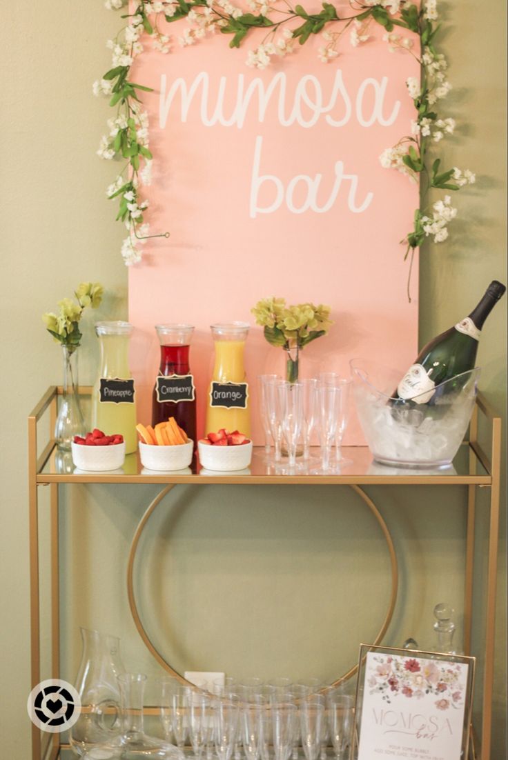 a bar cart with drinks and wine glasses on it, next to a sign that says minnesota bar