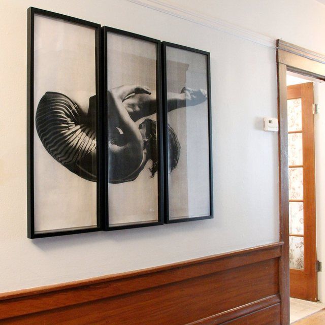 two black and white pictures hanging on the wall