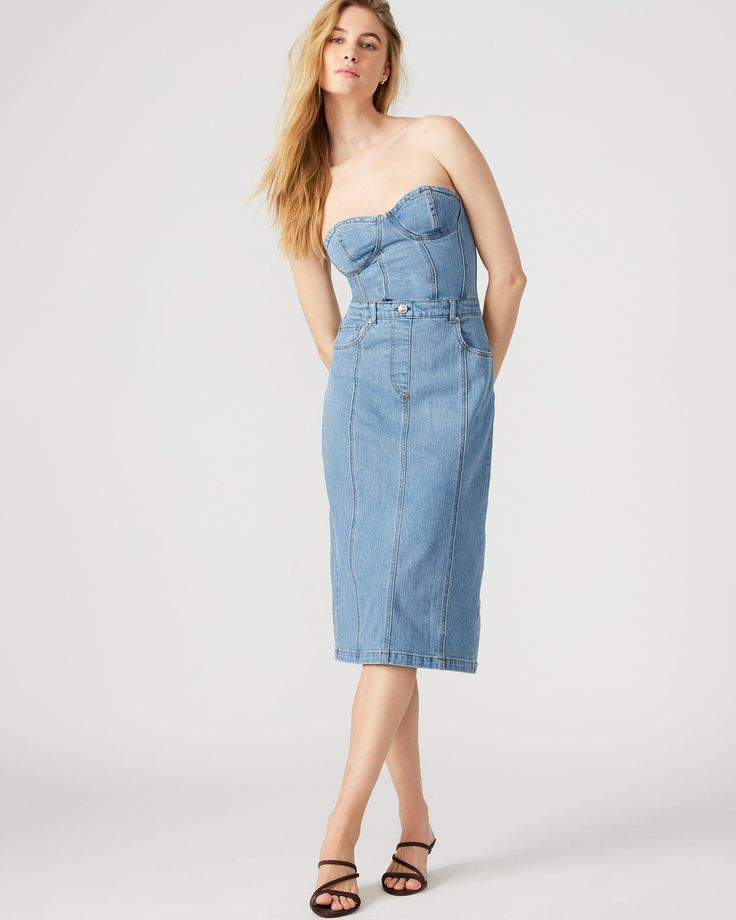 This denim dress combines the casual appeal of blue denim with the sophistication of a bustier top and pencil skirt. Perfect for a cocktail event or dinner out, the midi length offers just the right amount of coverage while still showing off your curves. Bustier denim midi dress Pencil skirt bottom Back zipper closure Length: 35.75" 98% cotton 2% spandex Hand wash Emma is 5ft 10in and is wearing a size small Imported Womens Denim Dress, Denim Midi Dress, Cocktail Event, Bustier Top, Denim Fabric, Wearing Dress, Midi Length, Denim Dress, Blue Denim