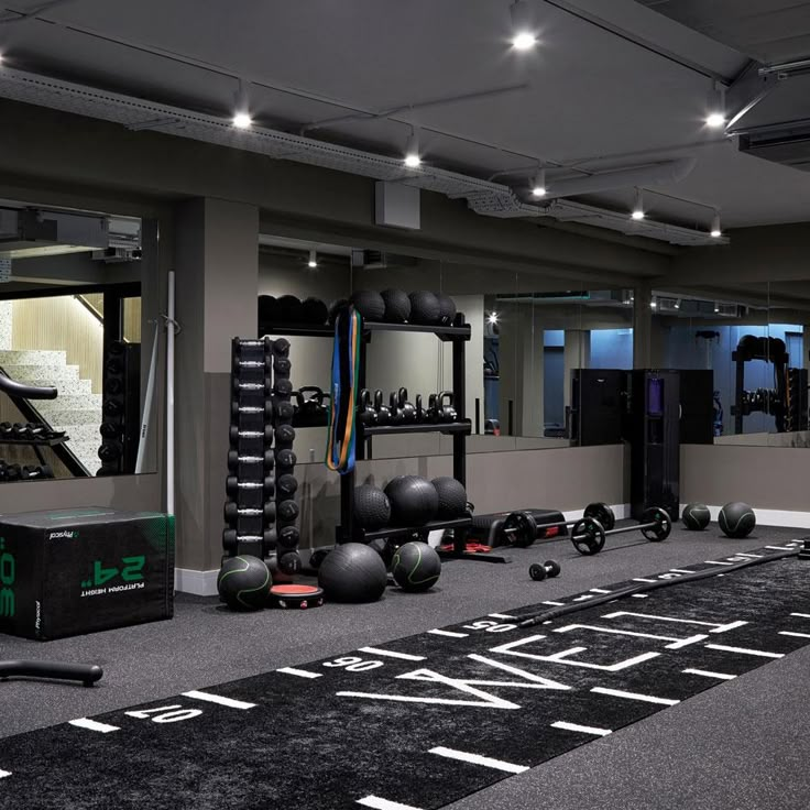 an empty gym room with exercise equipment in the foreground and on the right side