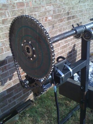 a large metal object sitting next to a brick wall