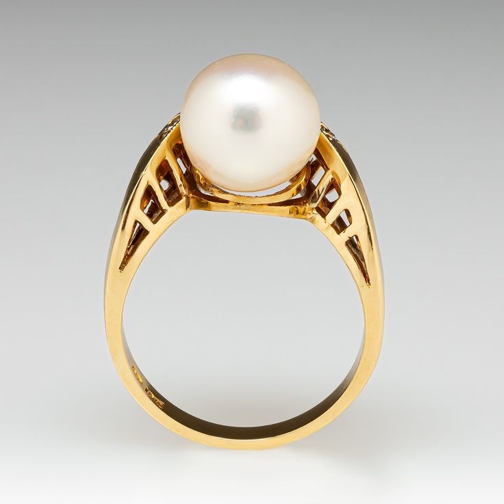 This elegant ring is centered with one (1), post set, cultured saltwater pearl. The pearl is accented to one side with sixteen (15), semi-bezel/bead set, round brilliant cut diamonds. The ring measures 15.3mm at the top, rises 11.0mm above the finger, tapering to 2.4mm wide and 0.9mm thick at the base of the shank. This ring is currently a size 7. Luxury White Pearl Ring, Luxury Pearl Ring With Brilliant Cut For Formal Occasions, Luxury Round Ring With Pearl Drop, Luxury Brilliant Cut Pearl Ring For Formal Occasions, Luxury Round Pearl Drop Ring, Formal Akoya Pearl Drop Rings, Luxury White Rings With Pearl Drop, Fine Jewelry Pearl Drop Ring For Formal Occasions, Luxury Pearl White Rings For Formal Occasions