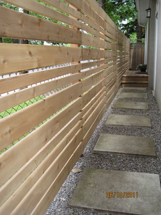 a wooden fence in front of a house