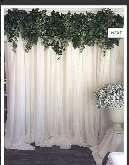 a white curtain with green leaves on it