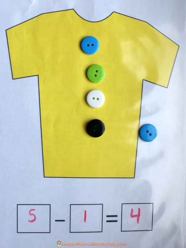 a paper bag with buttons on it and a t - shirt cut out in the middle