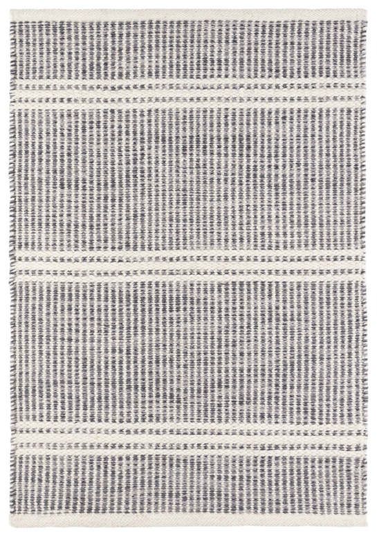 a gray and white rug with lines on the bottom, in two different colors that appear to be woven