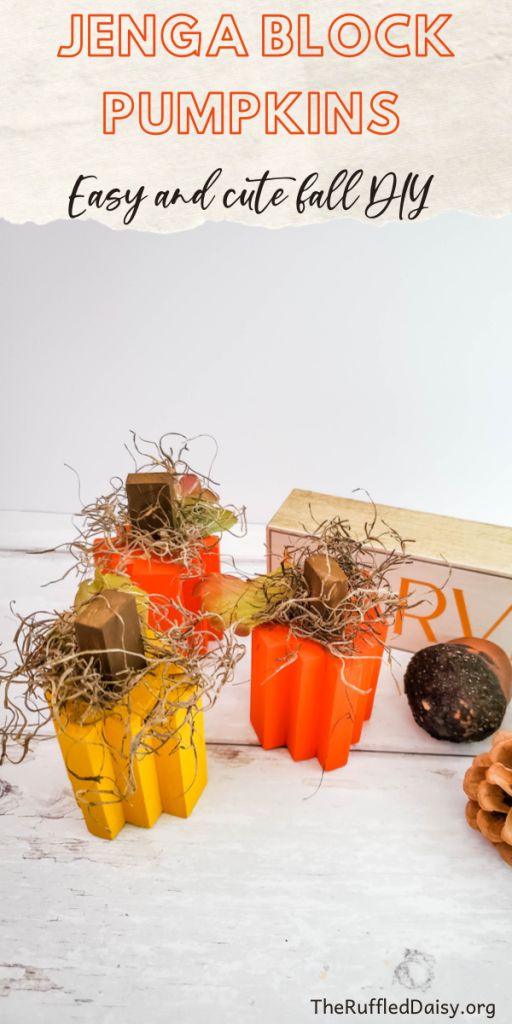 an orange and yellow box filled with pumpkins on top of a white tablecloth