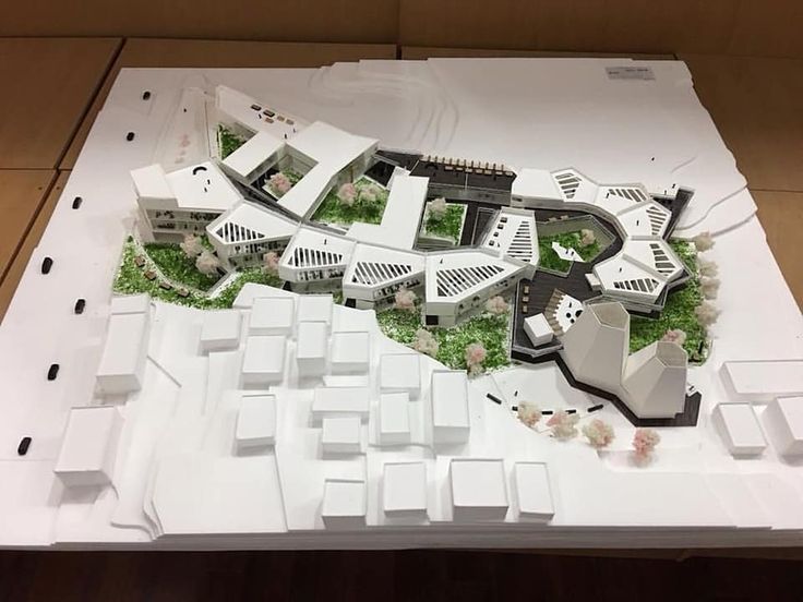 a model of a city with lots of trees and buildings on it's sides