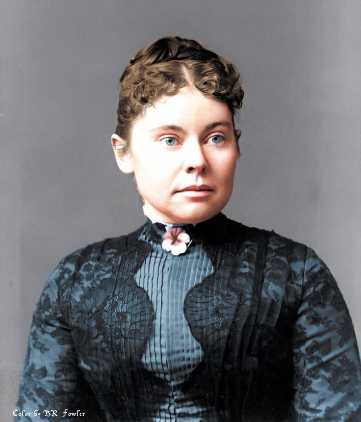 an old photo of a woman with curly hair wearing a dress and flower in her hair