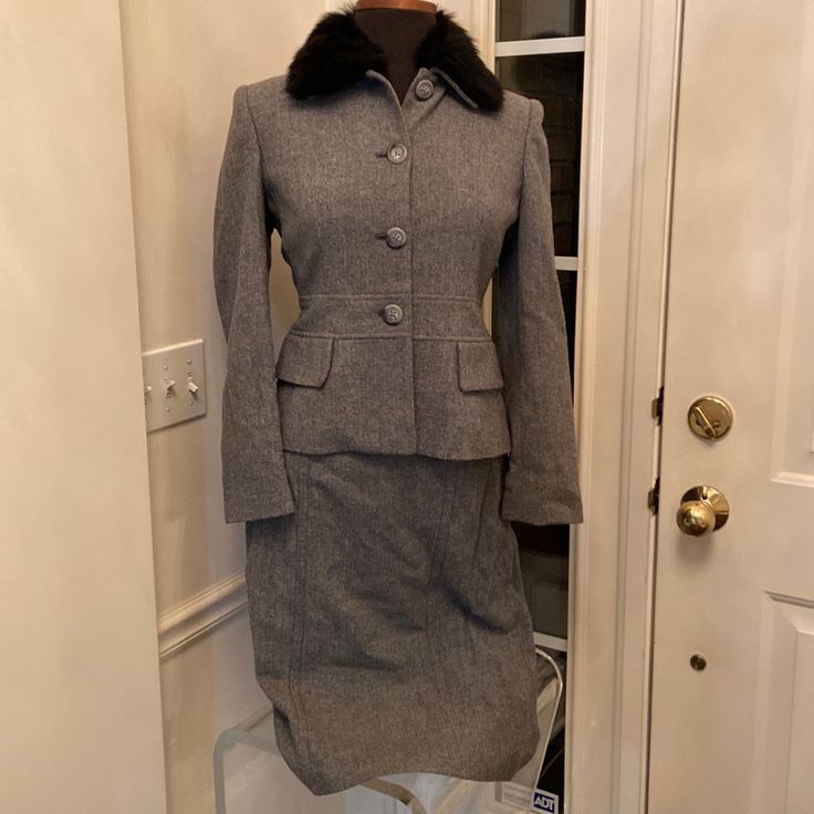 Gray Herringbone Print. Button Down Jacket. Boarder Designed Waistline. Lower Flap Welted Pockets. Button Detachable Fur Collar. Sz6p. Pencil Cut Skirt. Seam Detailing. Vented Rear Hemline. Sz 8p Cboth Fully Lined. Brand New. Excellent Condition Gray Fitted Button-up Outerwear, Classic Winter Skirt Suit For Semi-formal Occasions, Classic Winter Semi-formal Skirt Suit, Classic Fitted Wool Skirt Suit, Chic Semi-formal Winter Skirt Suit, Fitted Gray Outerwear For Office, Classic Fitted Winter Skirt Suit, Classic Fitted Skirt Suit For Winter, Chic Fitted Skirt Suit With Button Closure