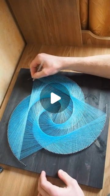 a person is working on some string art