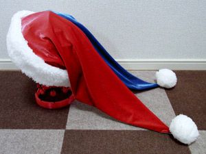 a red and blue hat laying on top of a checkered floor next to a wall